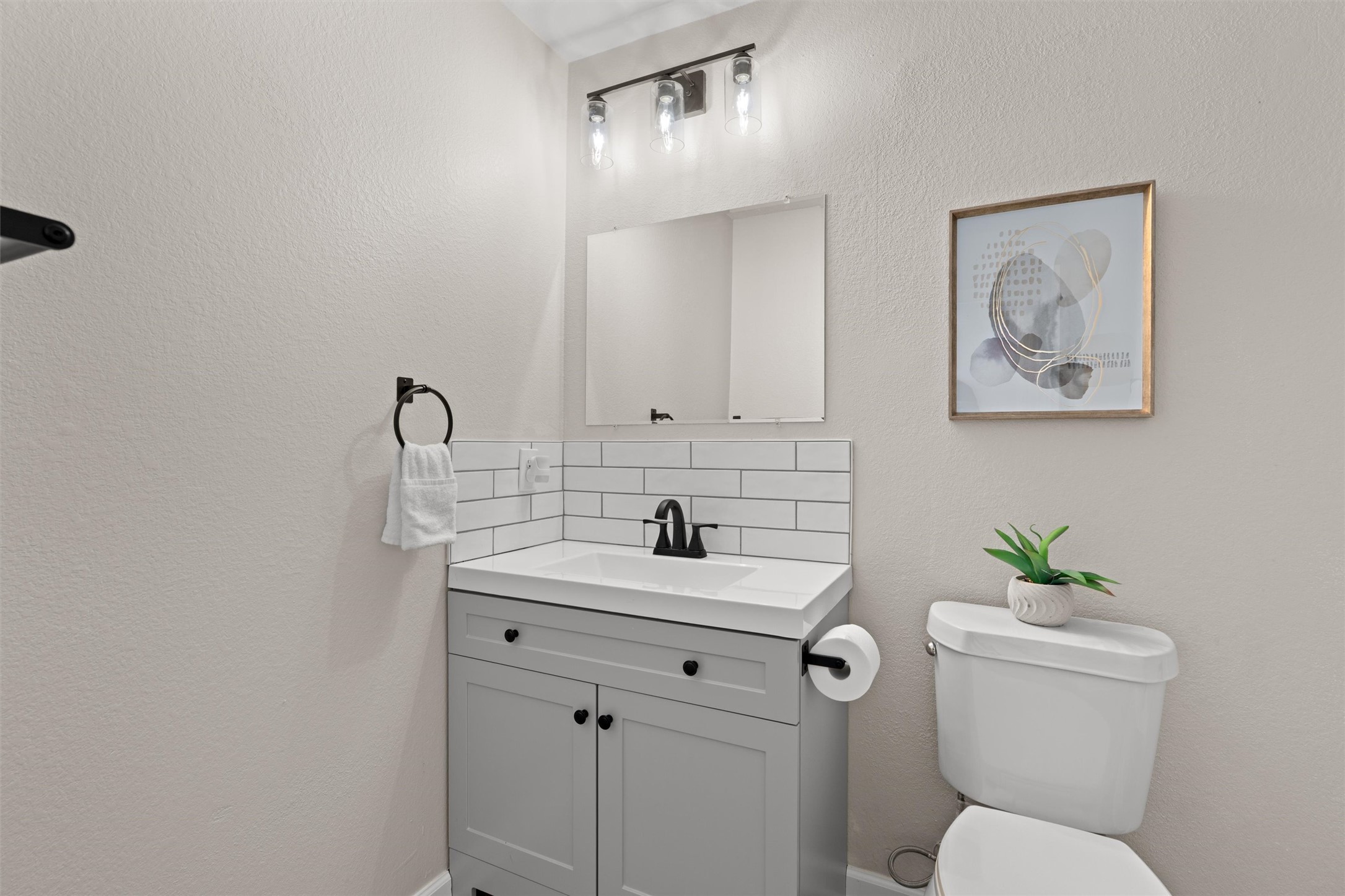 724 Lavaca Loop Elgin, TX 78621 - Photo 18 of 40 Clean modern finishes anchor this bathroom, accented by a classic subway tile backsplash.