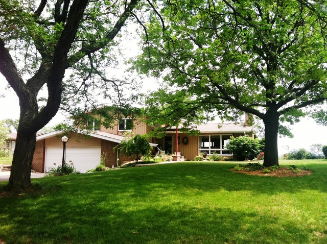 339 High Road Cary, IL 60013 - Photo 1 of 25 a front view of a house with a garden