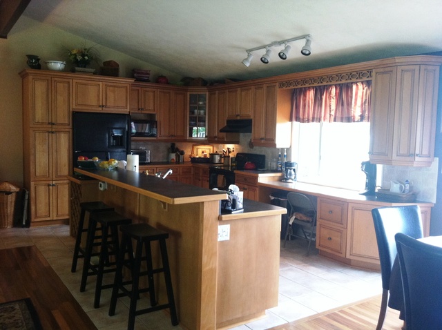 339 High Road Cary, IL 60013 - Photo 7 of 25 a kitchen with kitchen island granite countertop a sink cabinets and window