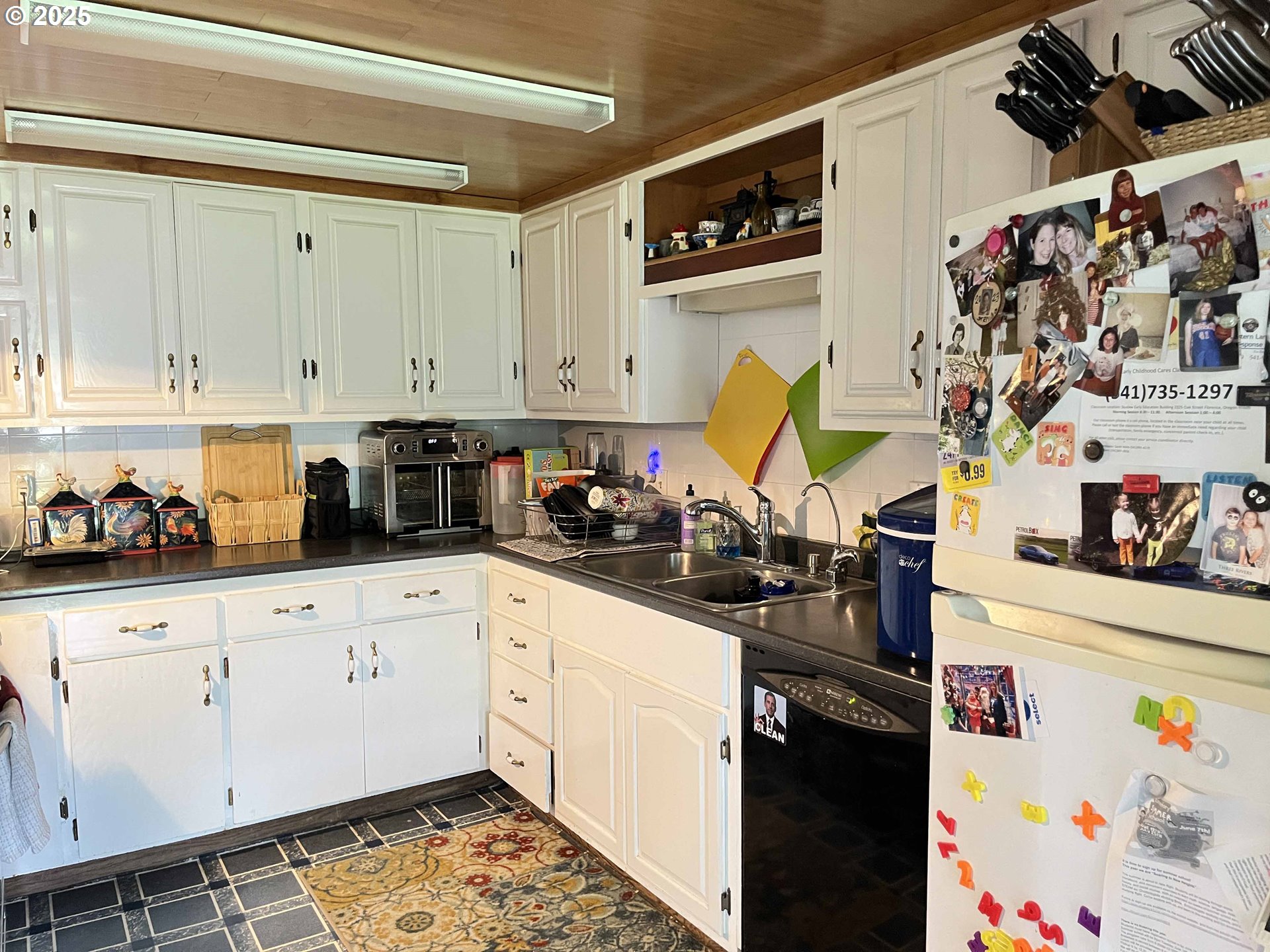 2385 19th Street Florence, OR 97439 - Photo 15 of 47 a kitchen with stainless steel appliances granite countertop a stove a sink and cabinets