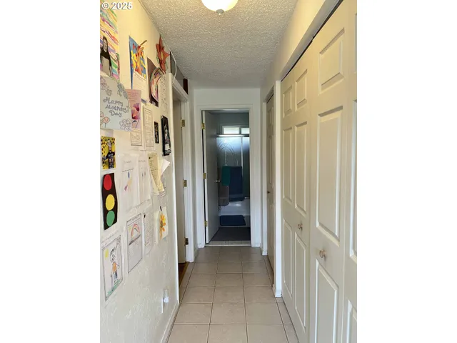 a view of a hallway with wooden cabinets