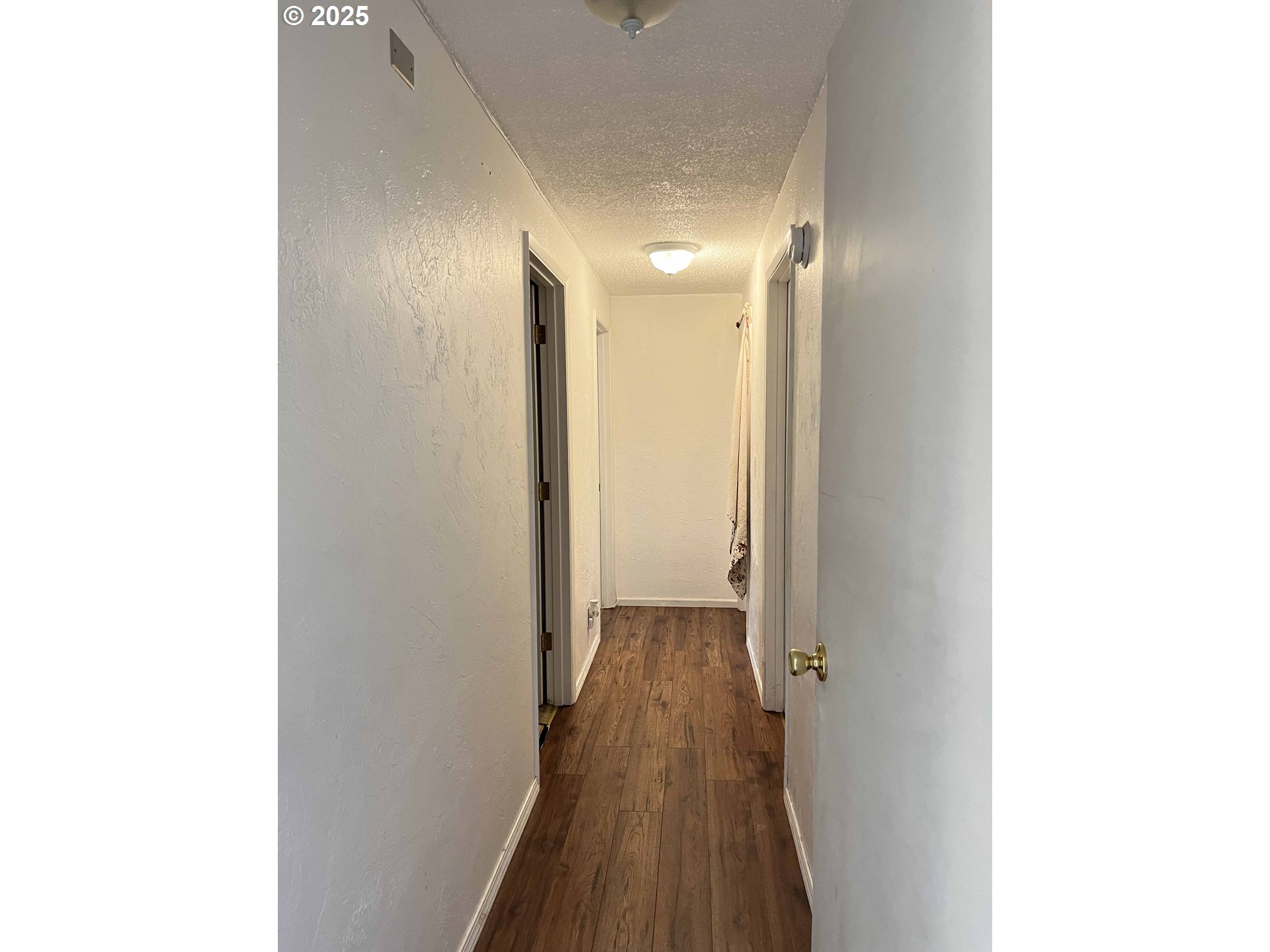 2385 19th Street Florence, OR 97439 - Photo 19 of 47 a view of a hallway with wooden floor