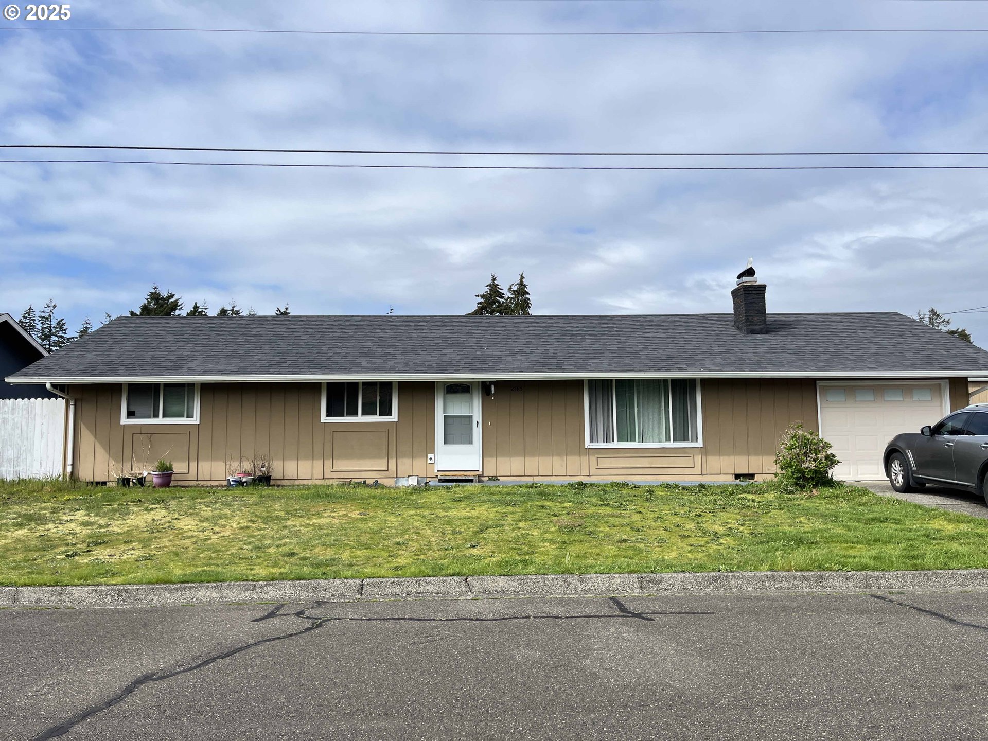 2385 19th Street Florence, OR 97439 - Photo 2 of 47 a front view of a house with a yard