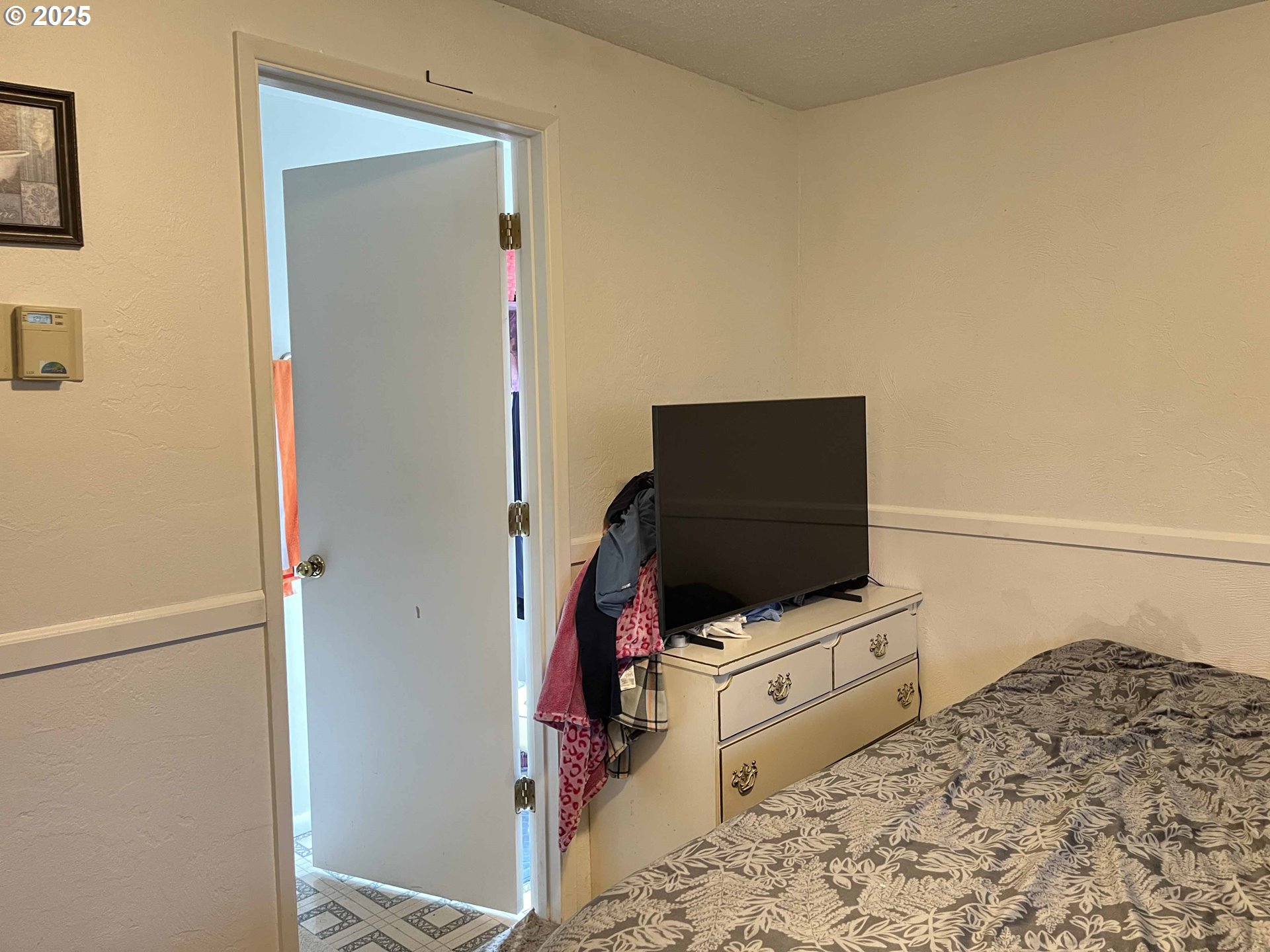 2385 19th Street Florence, OR 97439 - Photo 29 of 47 a bedroom with a bed and flat screen tv