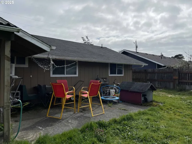 a view of a chairs and table in patio with a yard