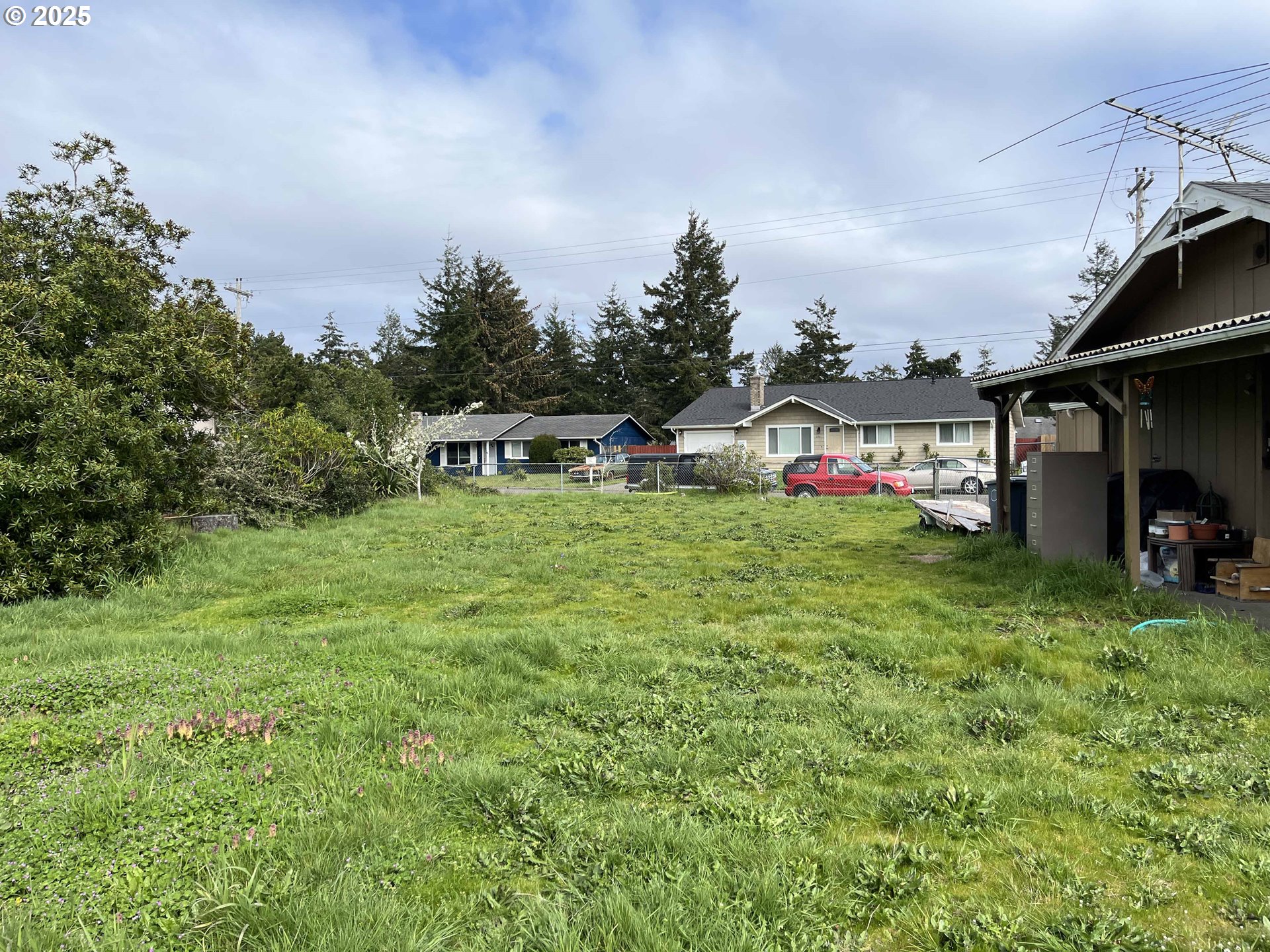 2385 19th Street Florence, OR 97439 - Photo 35 of 47 a view of a house with swimming pool and garden