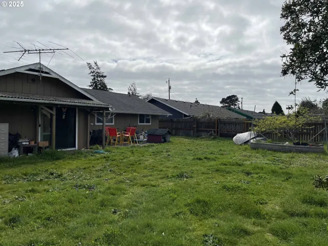 a view of a house with a yard and sitting area