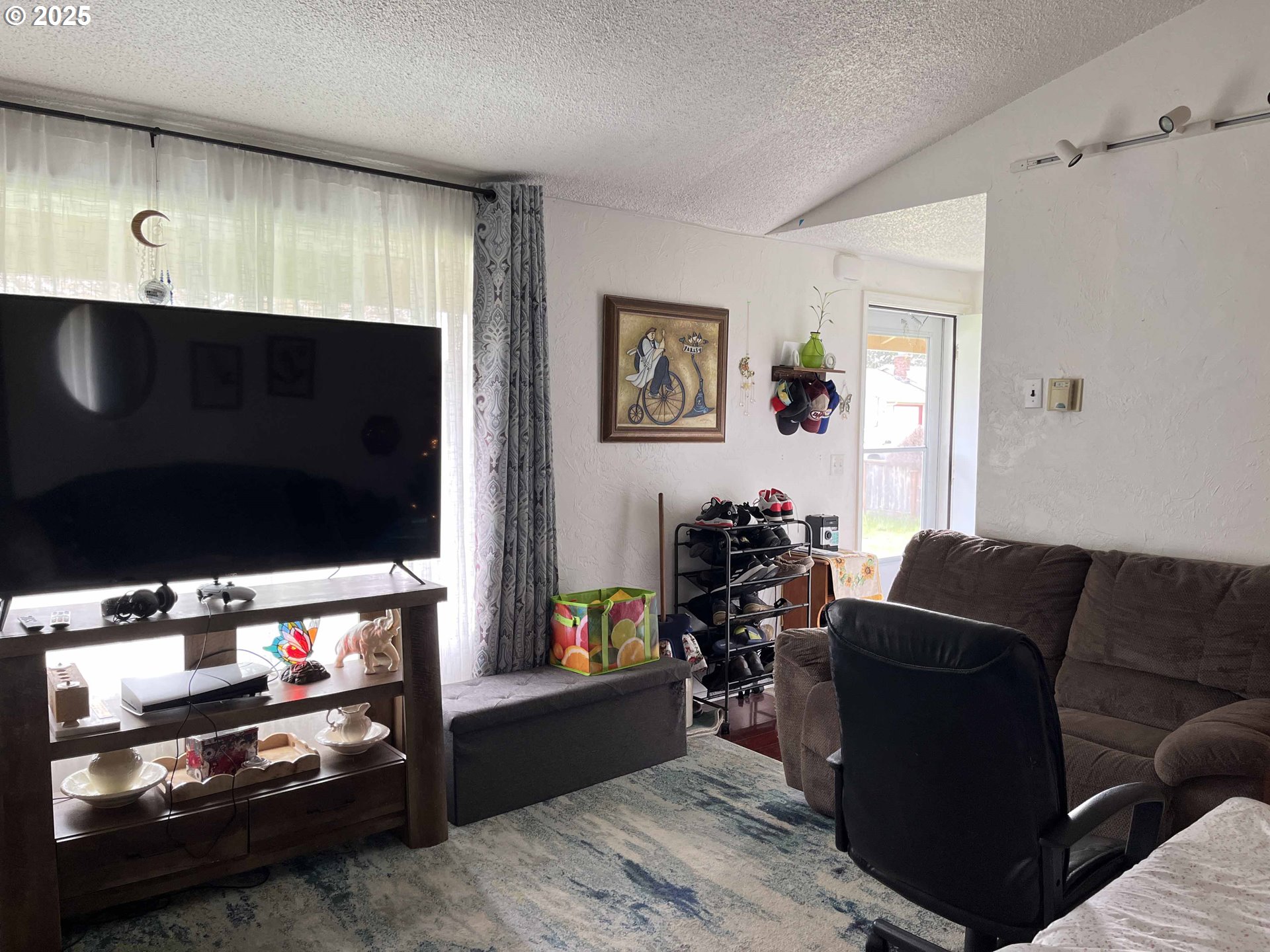 2385 19th Street Florence, OR 97439 - Photo 9 of 47 a living room with furniture and a flat screen tv