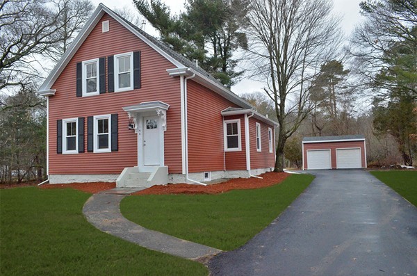 144 Pleasant Street Raynham, MA 02767 - Photo 1 of 29 a front view of a house with a yard and garage