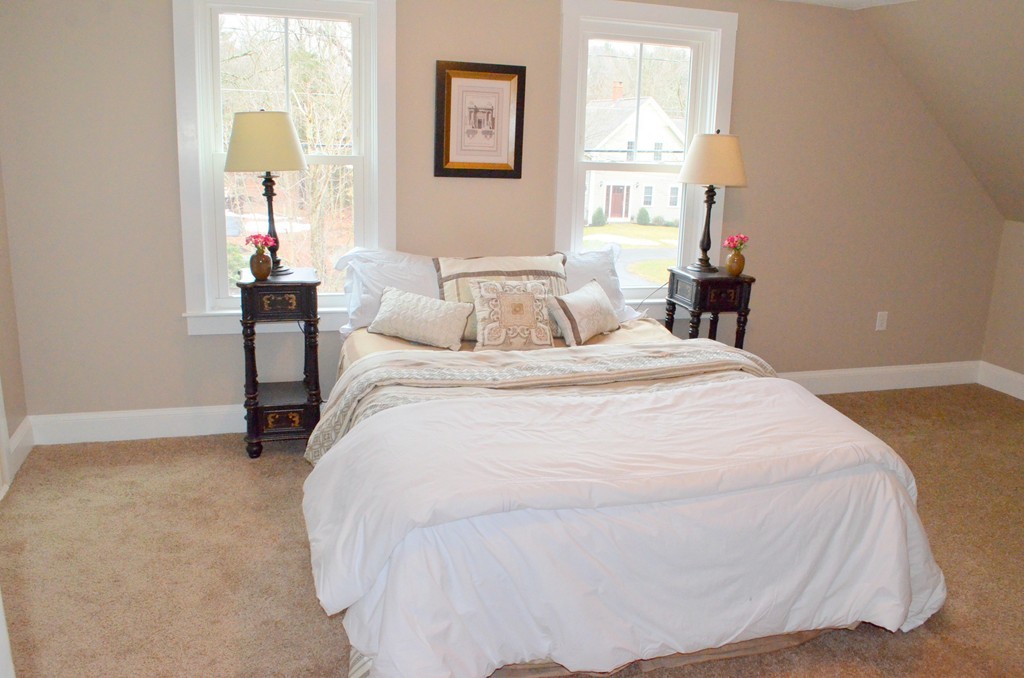 144 Pleasant Street Raynham, MA 02767 - Photo 11 of 29 a large white bed in a bedroom next to a window