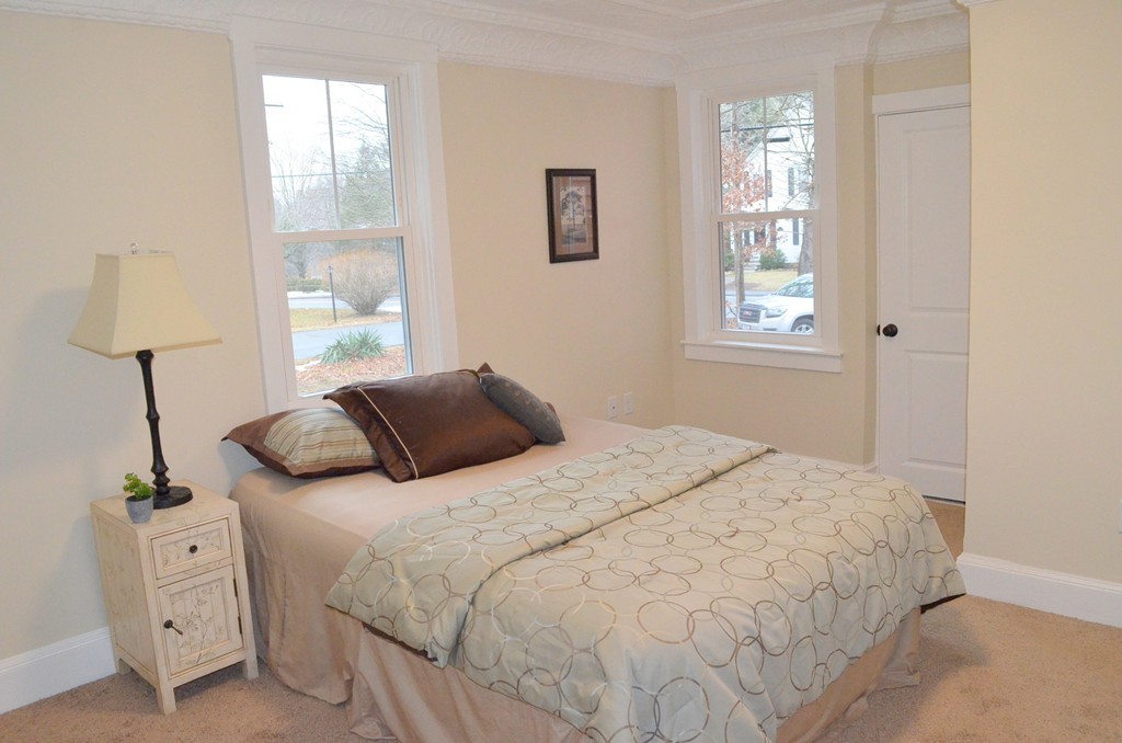 144 Pleasant Street Raynham, MA 02767 - Photo 12 of 29 a bedroom with a bed and a window