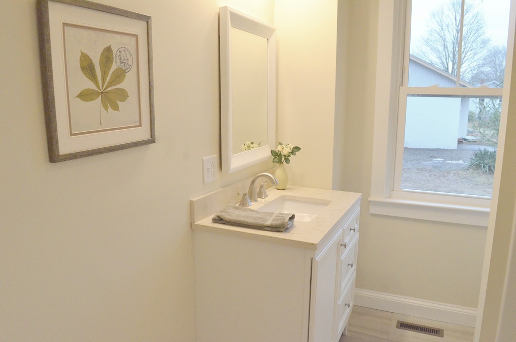 144 Pleasant Street Raynham, MA 02767 - Photo 14 of 29 a bathroom with a sink and a mirror