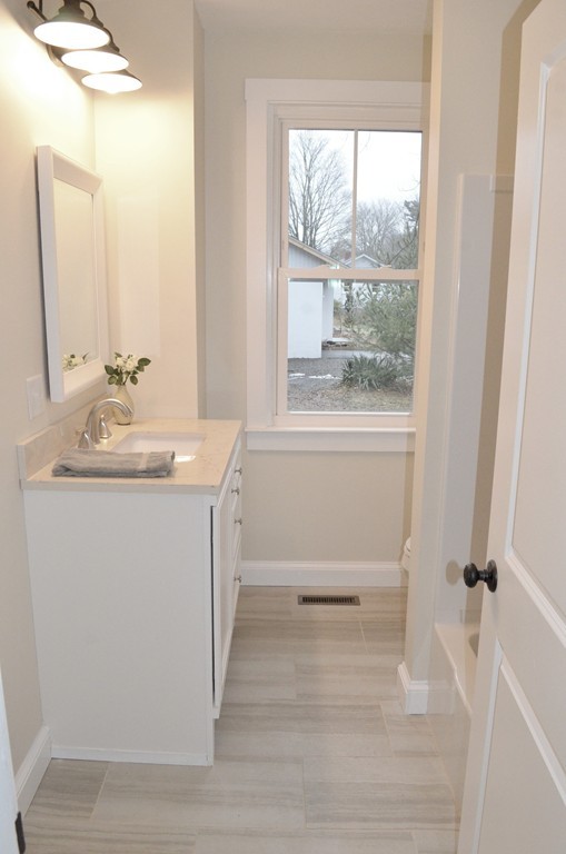 144 Pleasant Street Raynham, MA 02767 - Photo 15 of 29 a bathroom with a sink and a mirror