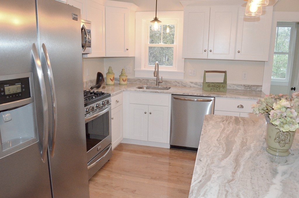 144 Pleasant Street Raynham, MA 02767 - Photo 21 of 29 a kitchen with a sink stove and refrigerator