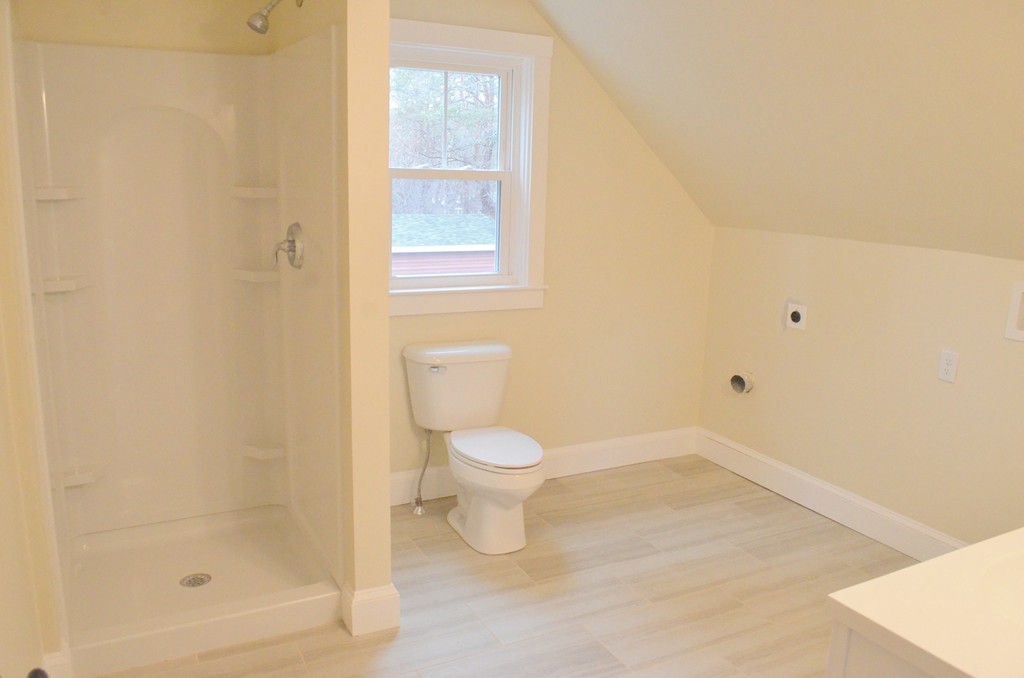 144 Pleasant Street Raynham, MA 02767 - Photo 23 of 29 a white toilet sitting next to a bathroom sink