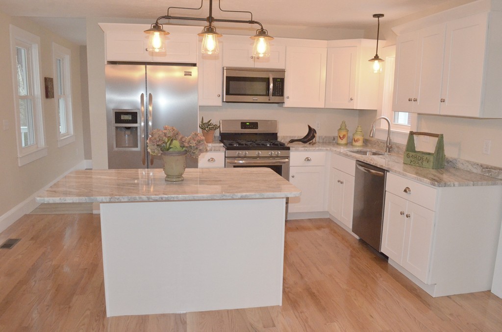 144 Pleasant Street Raynham, MA 02767 - Photo 3 of 29 a kitchen with stainless steel appliances granite countertop a stove sink microwave and refrigerator
