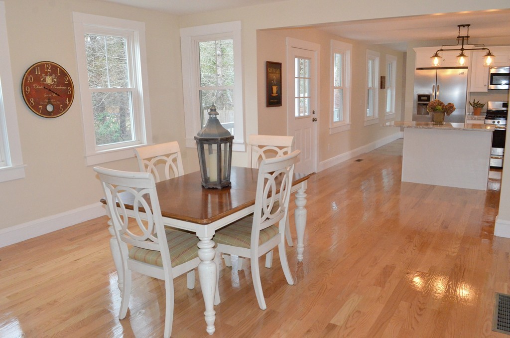 144 Pleasant Street Raynham, MA 02767 - Photo 5 of 29 a dining room with furniture and a clock