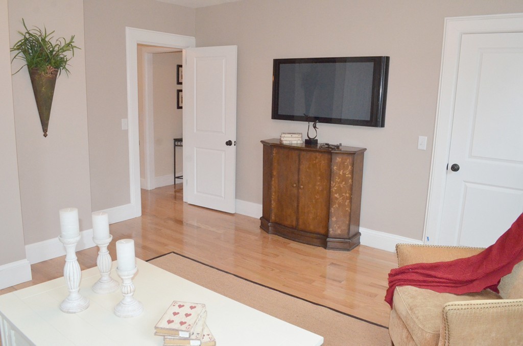 144 Pleasant Street Raynham, MA 02767 - Photo 7 of 29 a living room with furniture and a flat screen tv