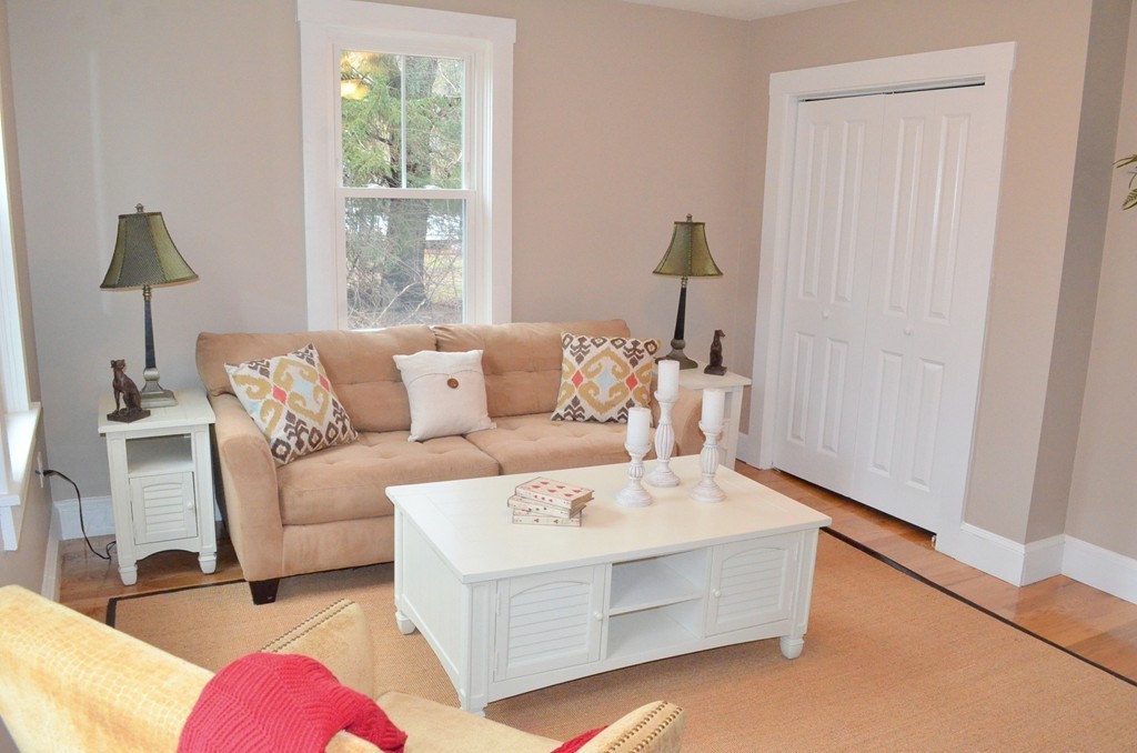 144 Pleasant Street Raynham, MA 02767 - Photo 8 of 29 a living room with furniture and a window