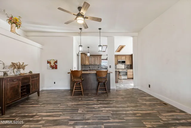 a living room with furniture fireplace and a large window
