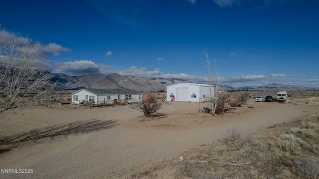 a view of a house with a snow in the yard