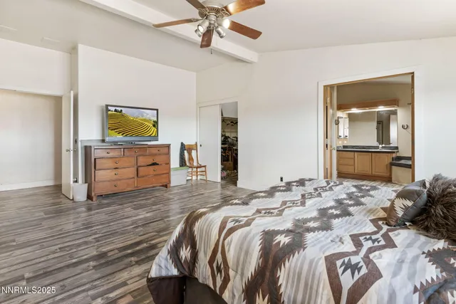a spacious bathroom with a granite countertop sink and a mirror