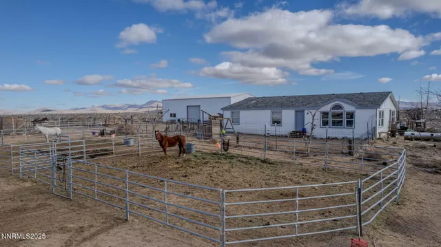 a view of a house with two chairs in front of house