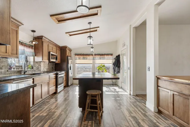 a kitchen with a sink cabinets and stainless steel appliances