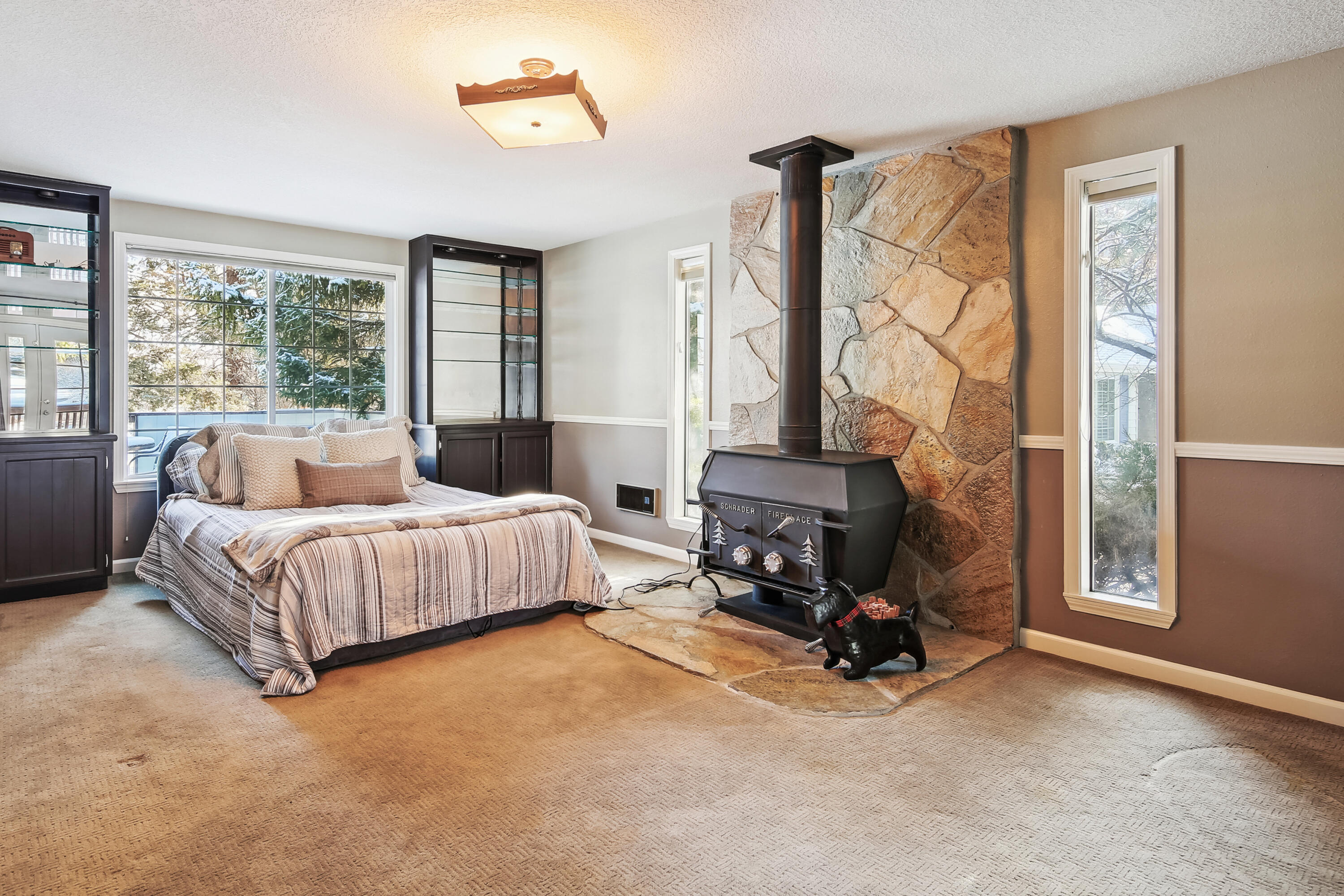 20466 Mainline Road Bend, OR 97702 - Photo 14 of 35 a bedroom with a bed and a chandelier