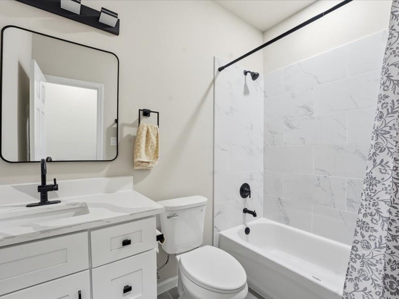 8708 Wileyvale Road Houston, TX 77016 - Photo 15 of 23 a bathroom with a bathtub shower sink vanity mirror and toilet