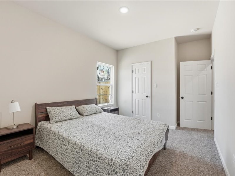 8708 Wileyvale Road Houston, TX 77016 - Photo 18 of 23 a bedroom with a bed and a night stand