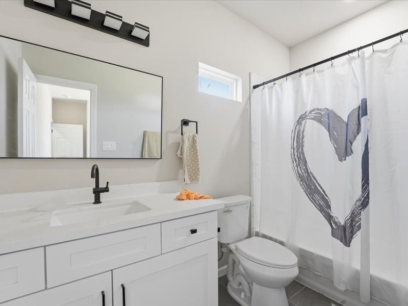 8708 Wileyvale Road Houston, TX 77016 - Photo 19 of 23 a bathroom with a sink a toilet and a mirror