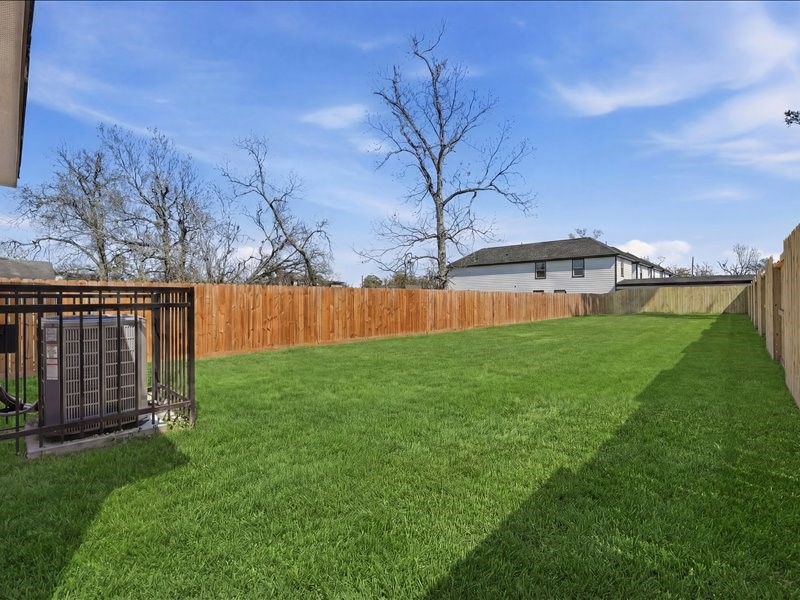 8708 Wileyvale Road Houston, TX 77016 - Photo 20 of 23 a view of a backyard with a large tree