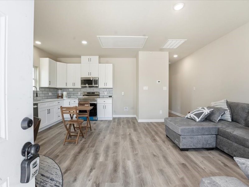 8708 Wileyvale Road Houston, TX 77016 - Photo 3 of 23 a living room with furniture and a dining table with kitchen view