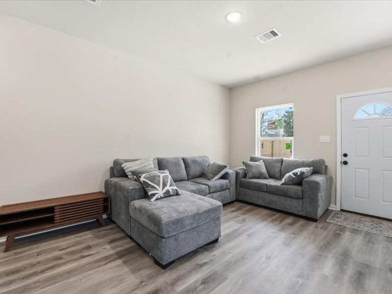 8708 Wileyvale Road Houston, TX 77016 - Photo 5 of 23 a living room with furniture and a wooden floor