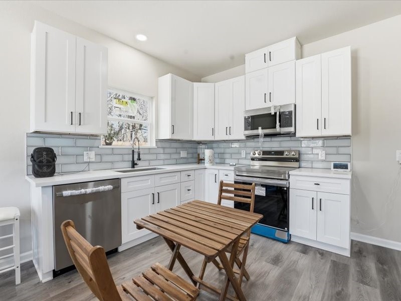 8708 Wileyvale Road Houston, TX 77016 - Photo 8 of 23 a kitchen with stainless steel appliances a stove a sink and white cabinets