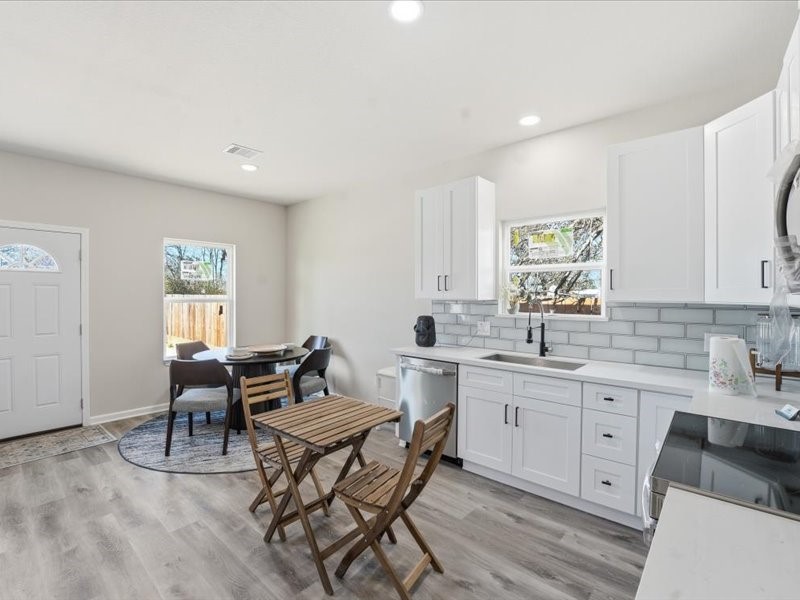 8708 Wileyvale Road Houston, TX 77016 - Photo 10 of 23 a kitchen with a sink dining table and chairs