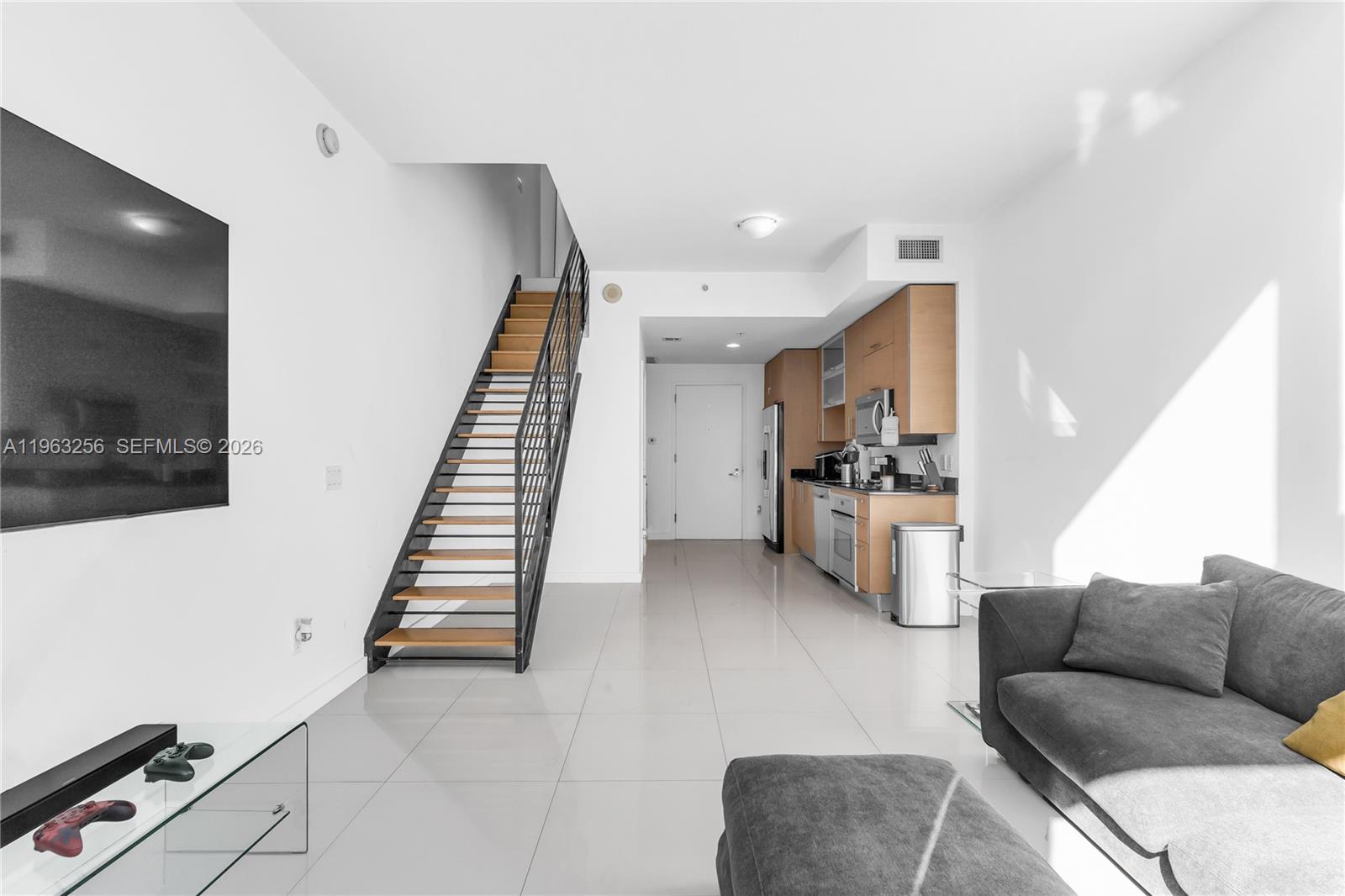 60 Southwest 13th Street, Unit 3416 Miami, FL 33130 - Photo 12 of 20 a living room with furniture and a flat screen tv