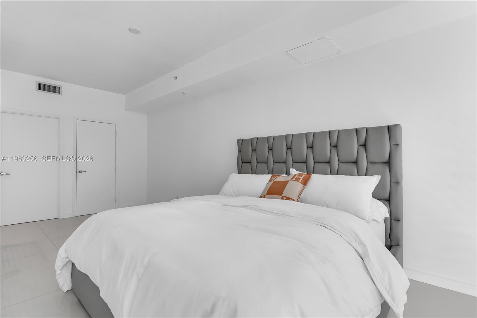 60 Southwest 13th Street, Unit 3416 Miami, FL 33130 - Photo 14 of 20 a bed sitting in a bedroom next to a cabinet