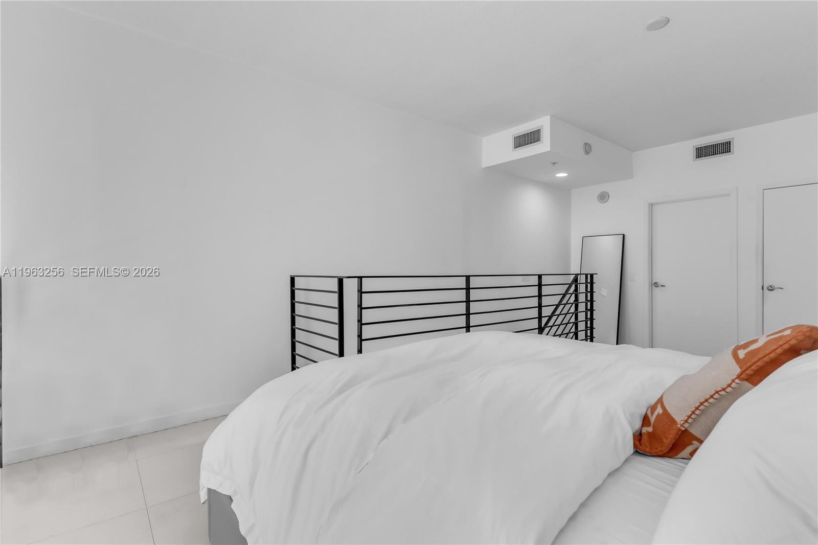 60 Southwest 13th Street, Unit 3416 Miami, FL 33130 - Photo 15 of 20 a large bed sitting in a bedroom and chandelier