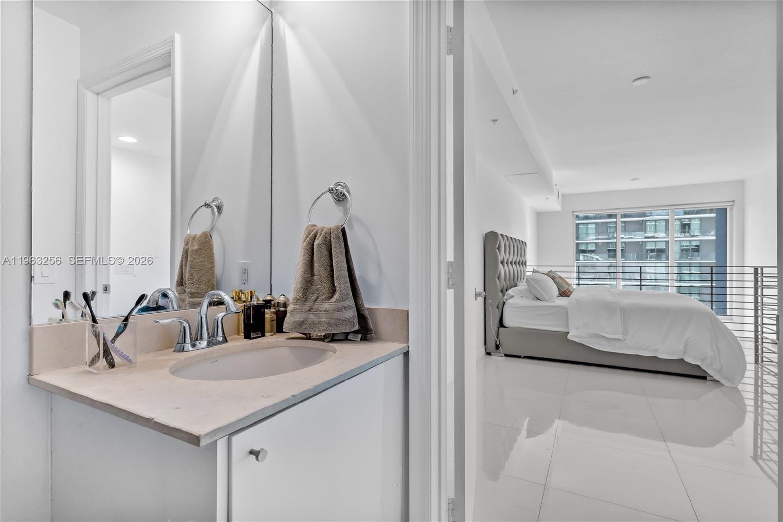 60 Southwest 13th Street, Unit 3416 Miami, FL 33130 - Photo 17 of 20 a en suite bathroom with sink and mirror