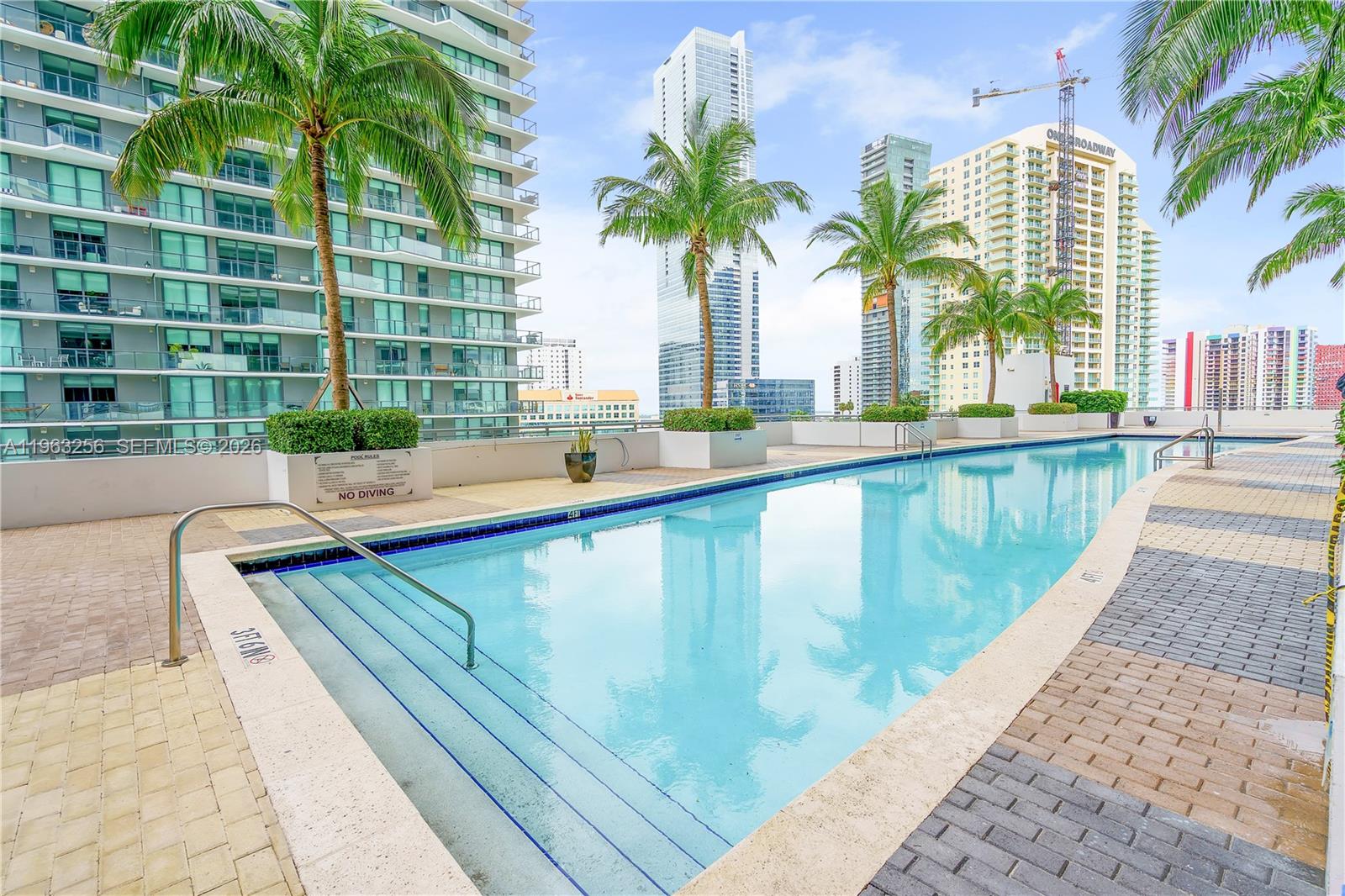 60 Southwest 13th Street, Unit 3416 Miami, FL 33130 - Photo 4 of 20 a swimming pool with outdoor seating and yard