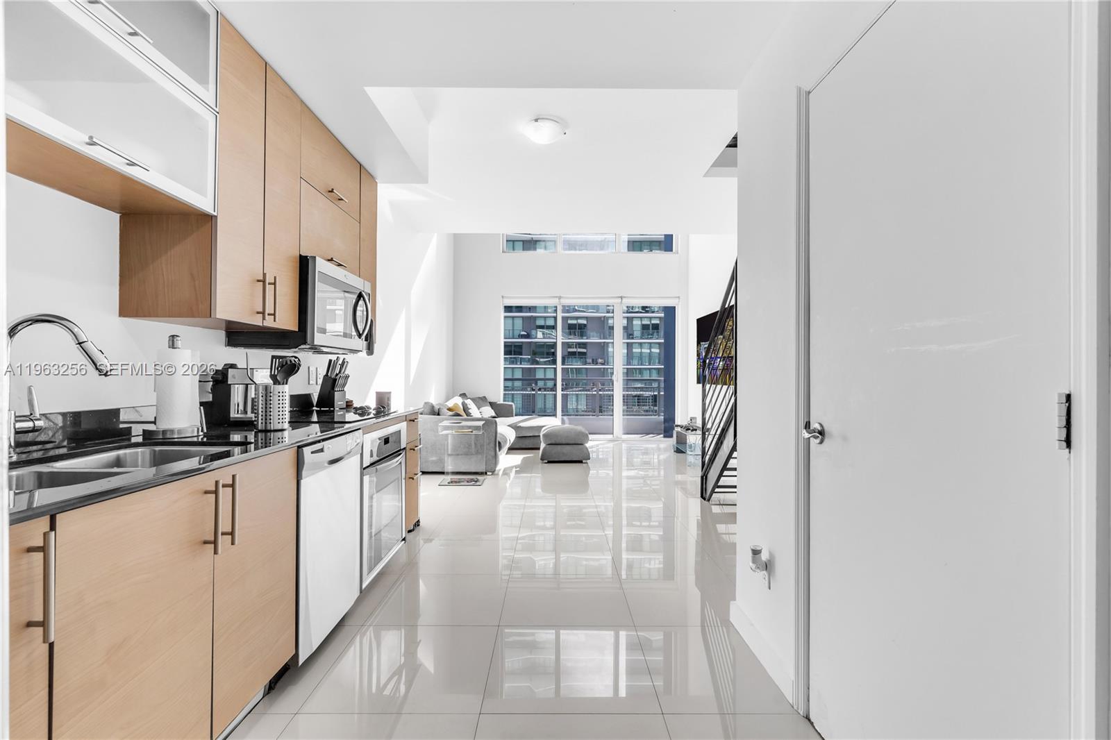 60 Southwest 13th Street, Unit 3416 Miami, FL 33130 - Photo 7 of 20 a kitchen with sink refrigerator and cabinets