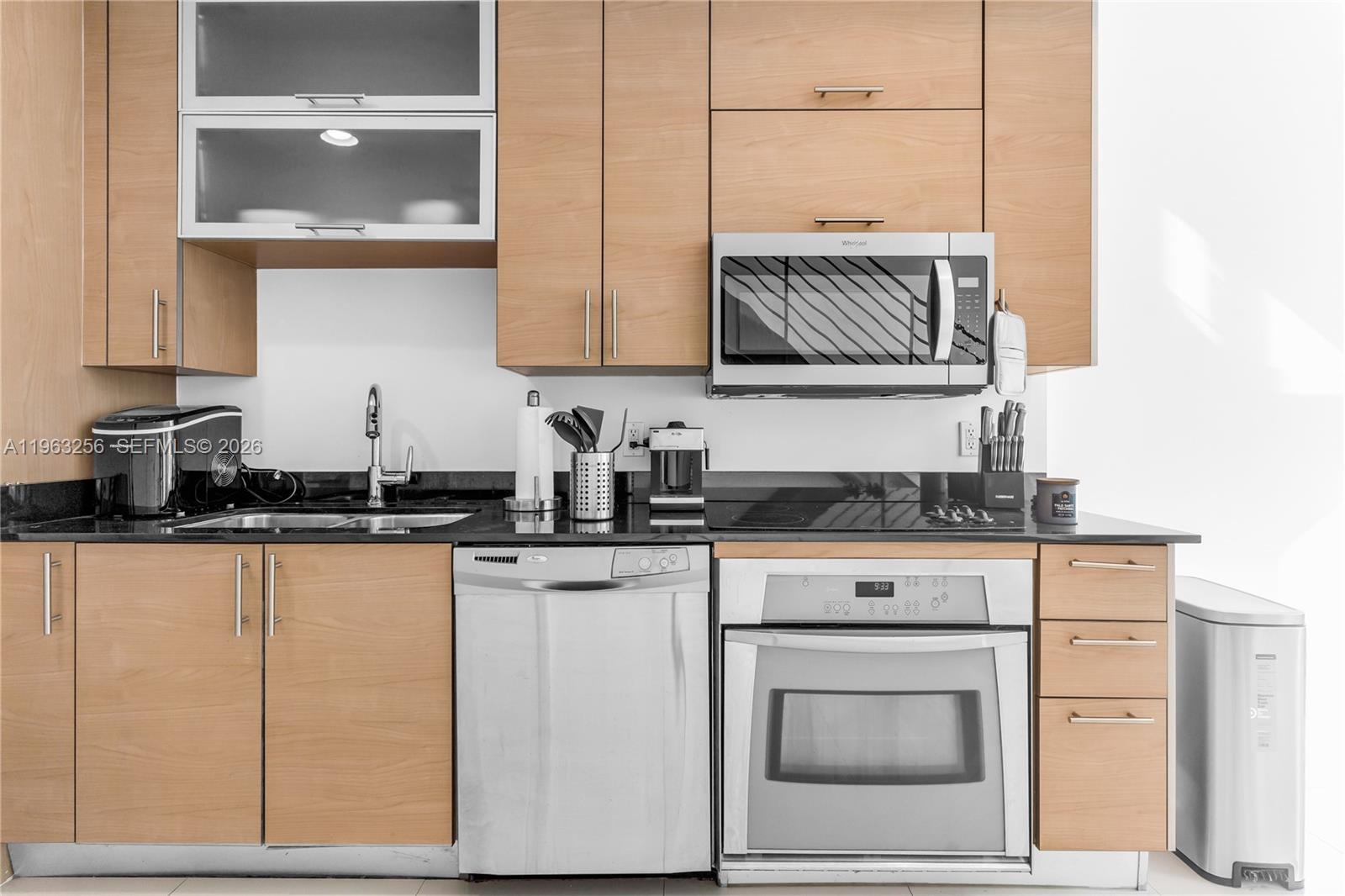 60 Southwest 13th Street, Unit 3416 Miami, FL 33130 - Photo 8 of 20 a kitchen with granite countertop a sink and cabinets