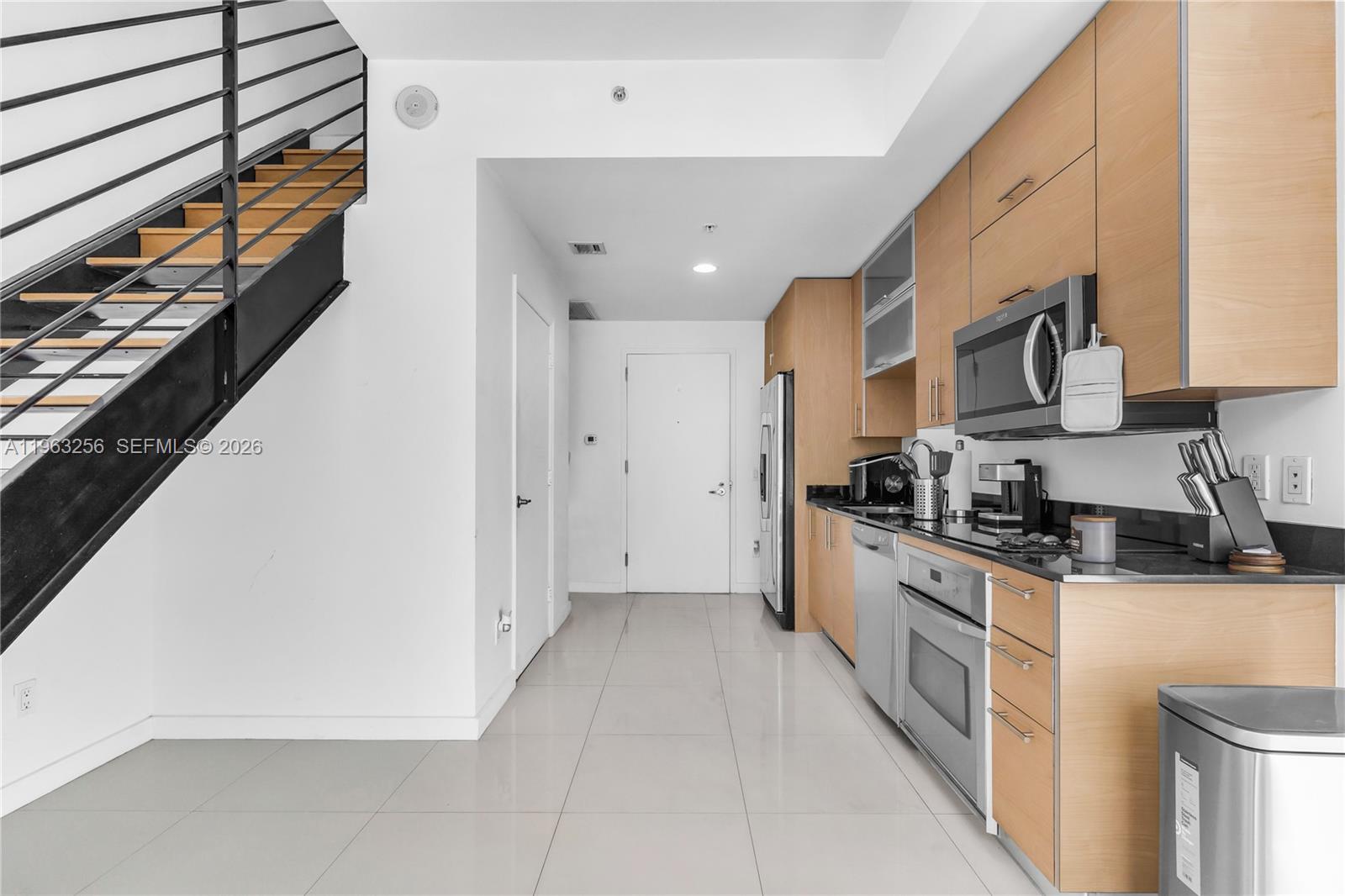 60 Southwest 13th Street, Unit 3416 Miami, FL 33130 - Photo 10 of 20 a kitchen with stainless steel appliances granite countertop a stove a sink and a refrigerator