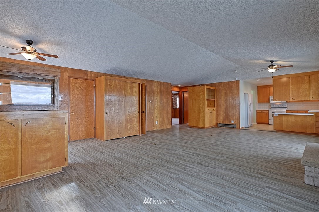2017 Vernon Road Lake Stevens, WA 98258 - Photo 12 of 25 a view of a livingroom with a kitchen counter tops and empty room with wooden floor