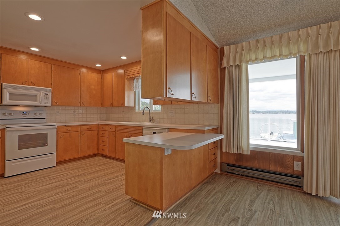 2017 Vernon Road Lake Stevens, WA 98258 - Photo 14 of 25 a kitchen with a sink stove top oven and cabinets