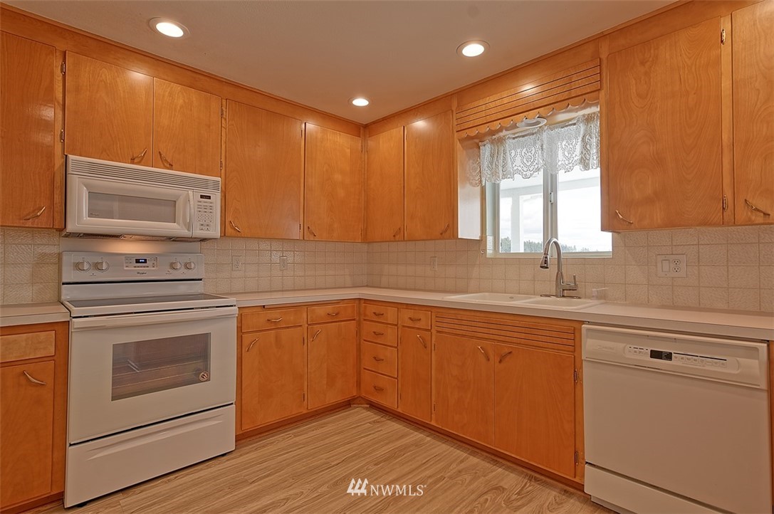 2017 Vernon Road Lake Stevens, WA 98258 - Photo 16 of 25 a kitchen with granite countertop cabinets stainless steel appliances and a sink