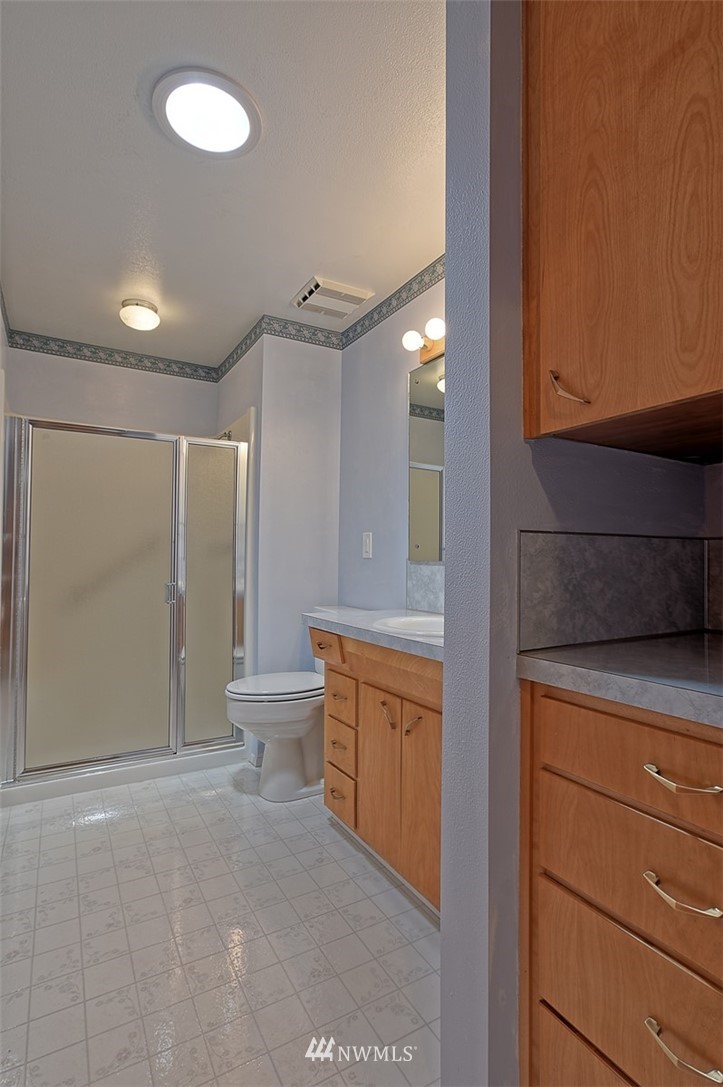 2017 Vernon Road Lake Stevens, WA 98258 - Photo 22 of 25 a bathroom with a granite countertop sink a toilet and shower