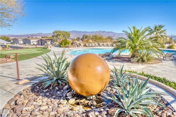 a view of a swimming pool with a patio and a garden